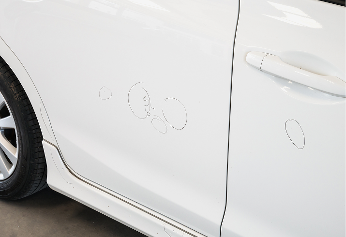 Car door with dents and scratches.