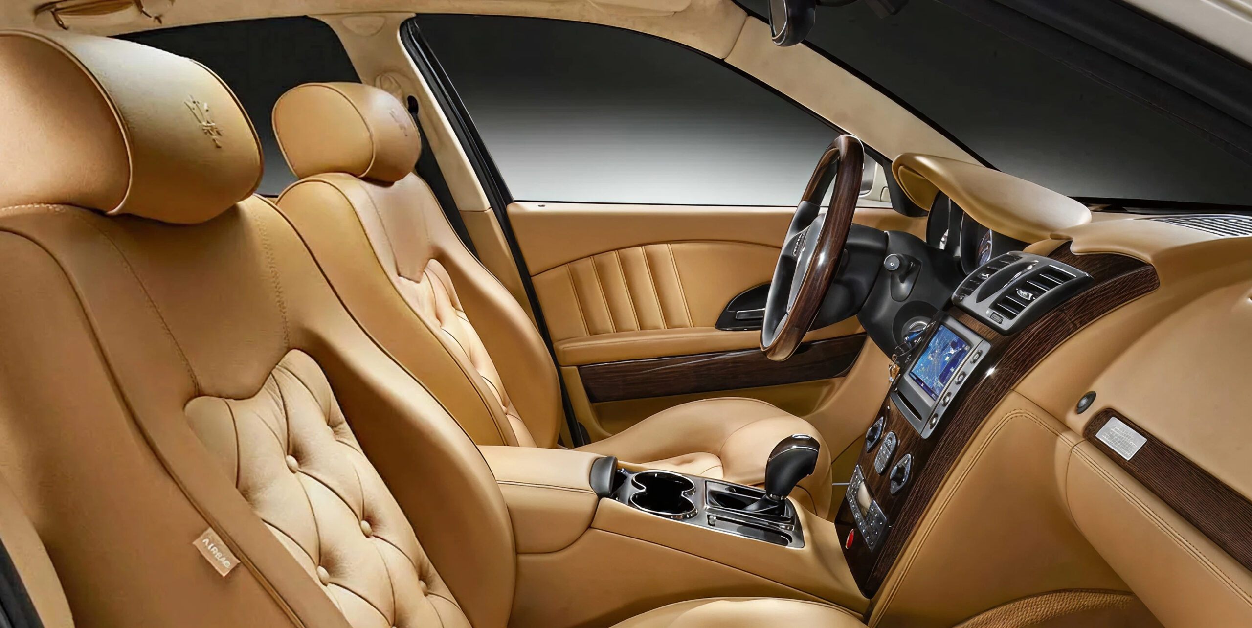 Luxury car interior with tan leather seats.
